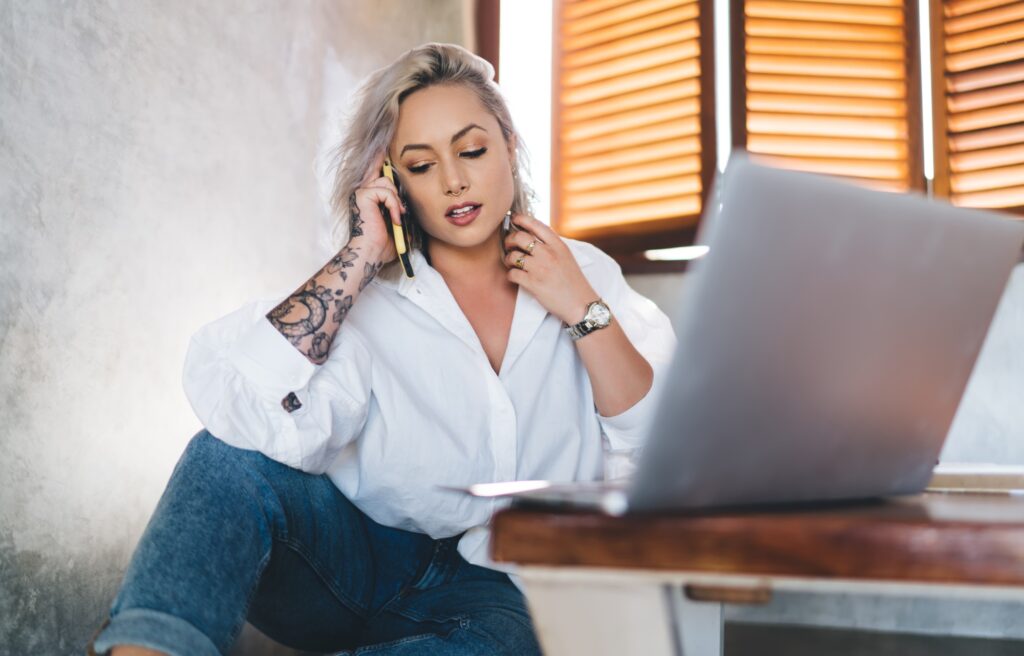 Skilled freelancer making consultancy conversation via cellphone